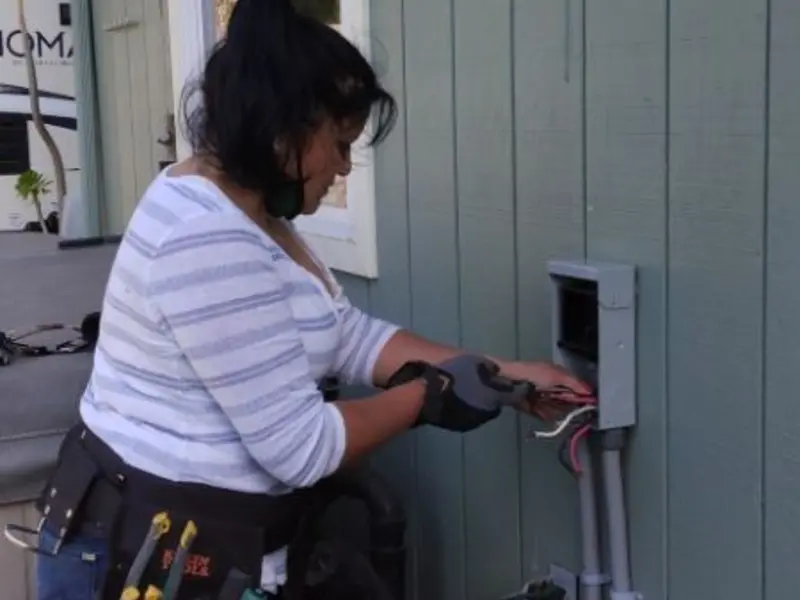 Licensed electrician wiring an exterior subpanel in Harvard